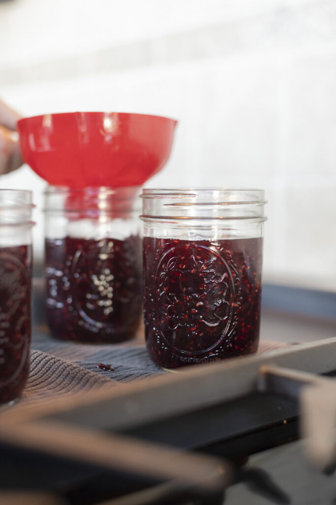 raspberry jam in jars ready for processing