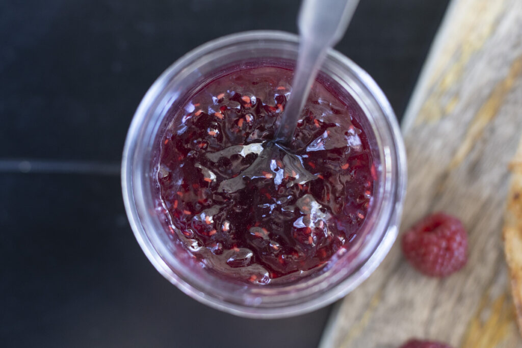 raspberry jam in jar with spoon