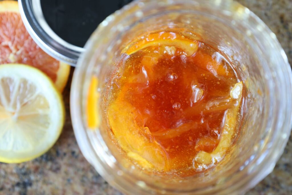 close of photo of homemade orange marmalade in jar with peel