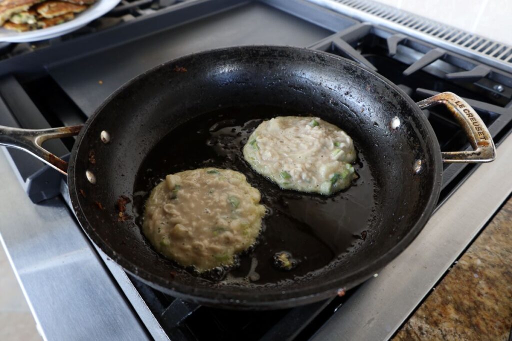 two traditional Irish boxty frying in a pan