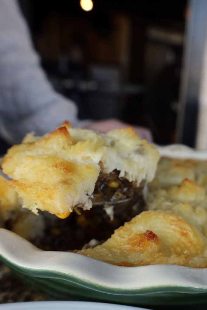 slice of classic shepherds pie coming out of the dish