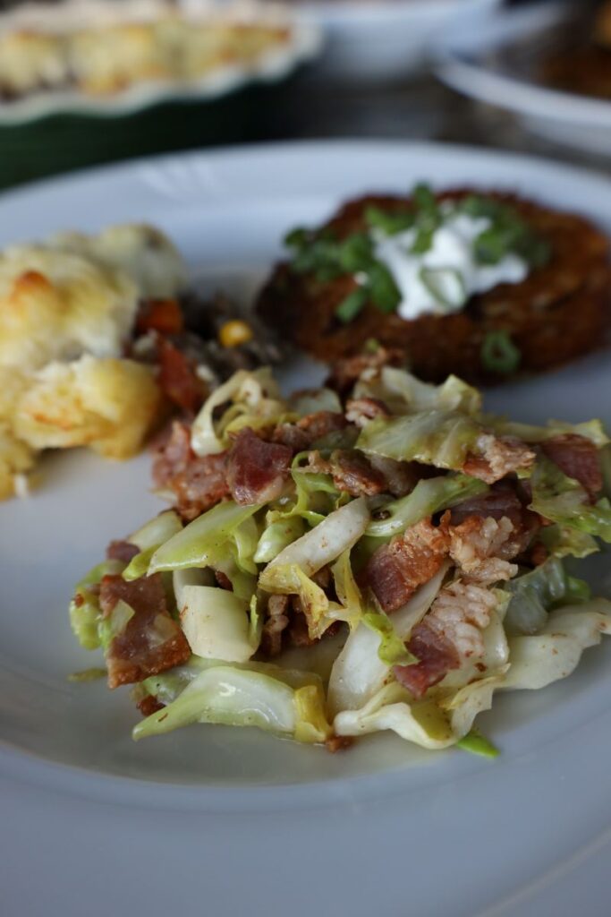 irish friend bacon and cabbage on a plate with potato pancake and shepherds pie